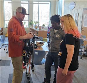 Students looking at climbing gear