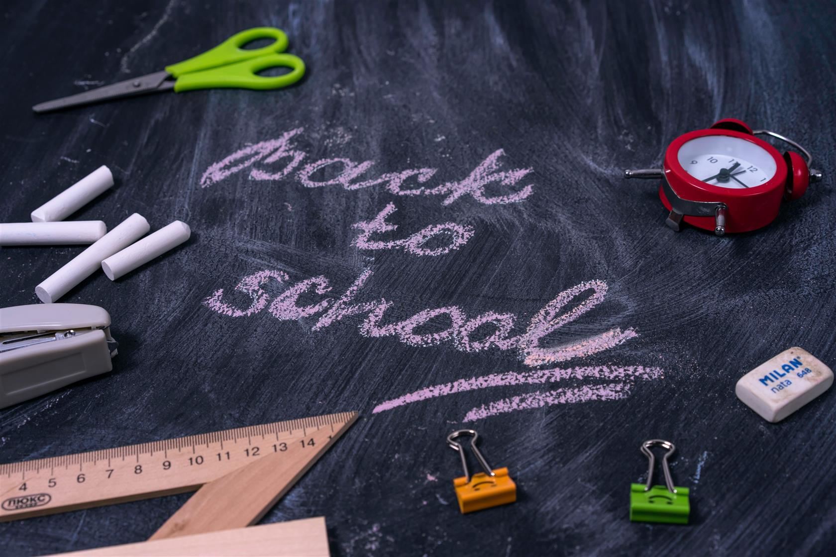  Black board with the words Back to School written in chalk.