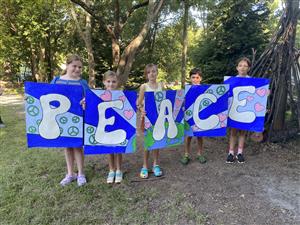 Students holding PEACE signs