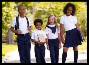 students wearing white tops and navy pants/skirts