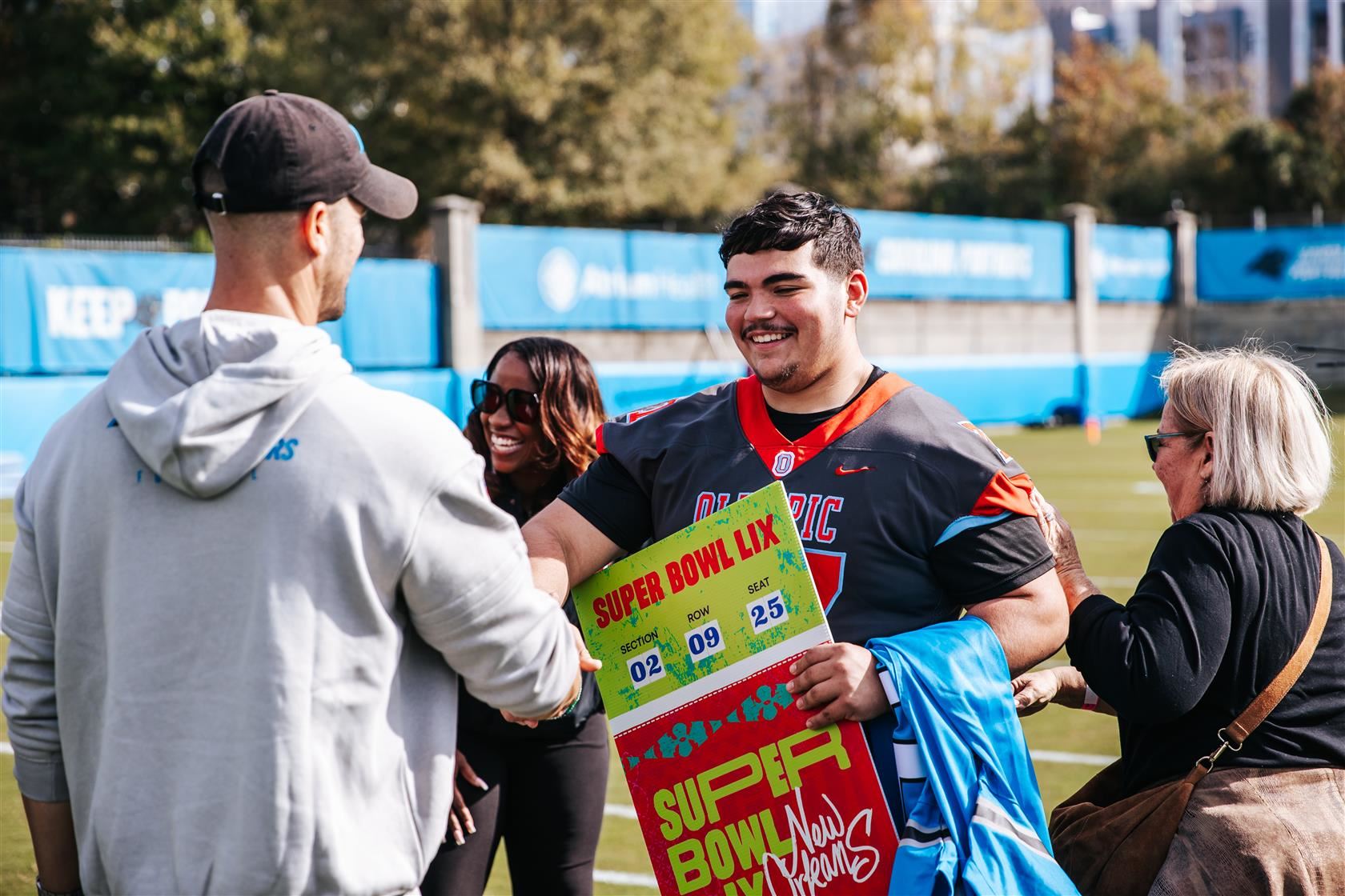 Carranza shakes hands with Carolina Panthers Head Coach Dave Canales