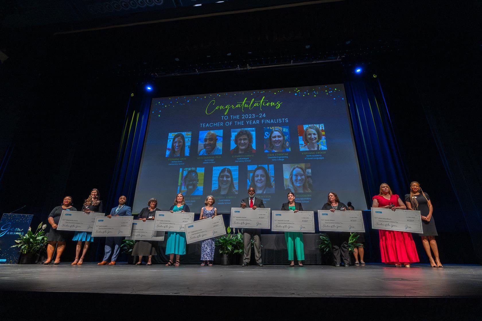 Teacher of the Year Finalists on stage holding checks