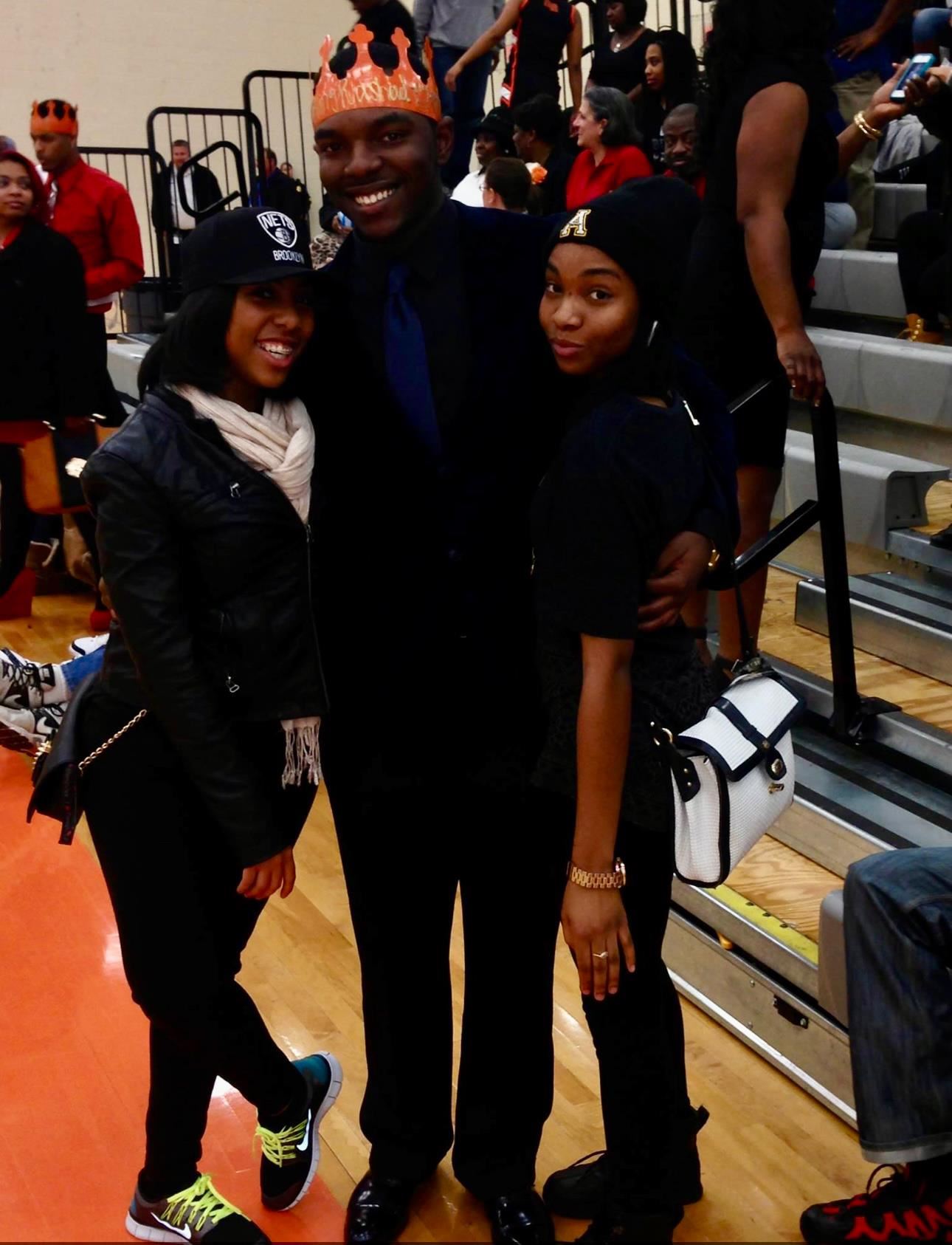 Malaysha Belton, right, stands with two classmates in Rocky River High's gym