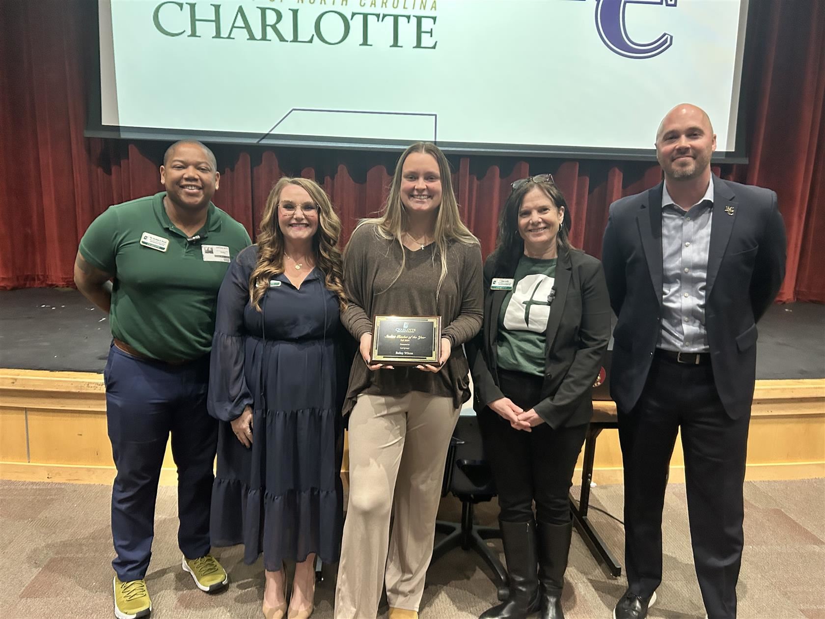 Bailey Wilcox, center, stands with UNC Charlotte representatives and Mallard Creek High Principal Jared Thompson