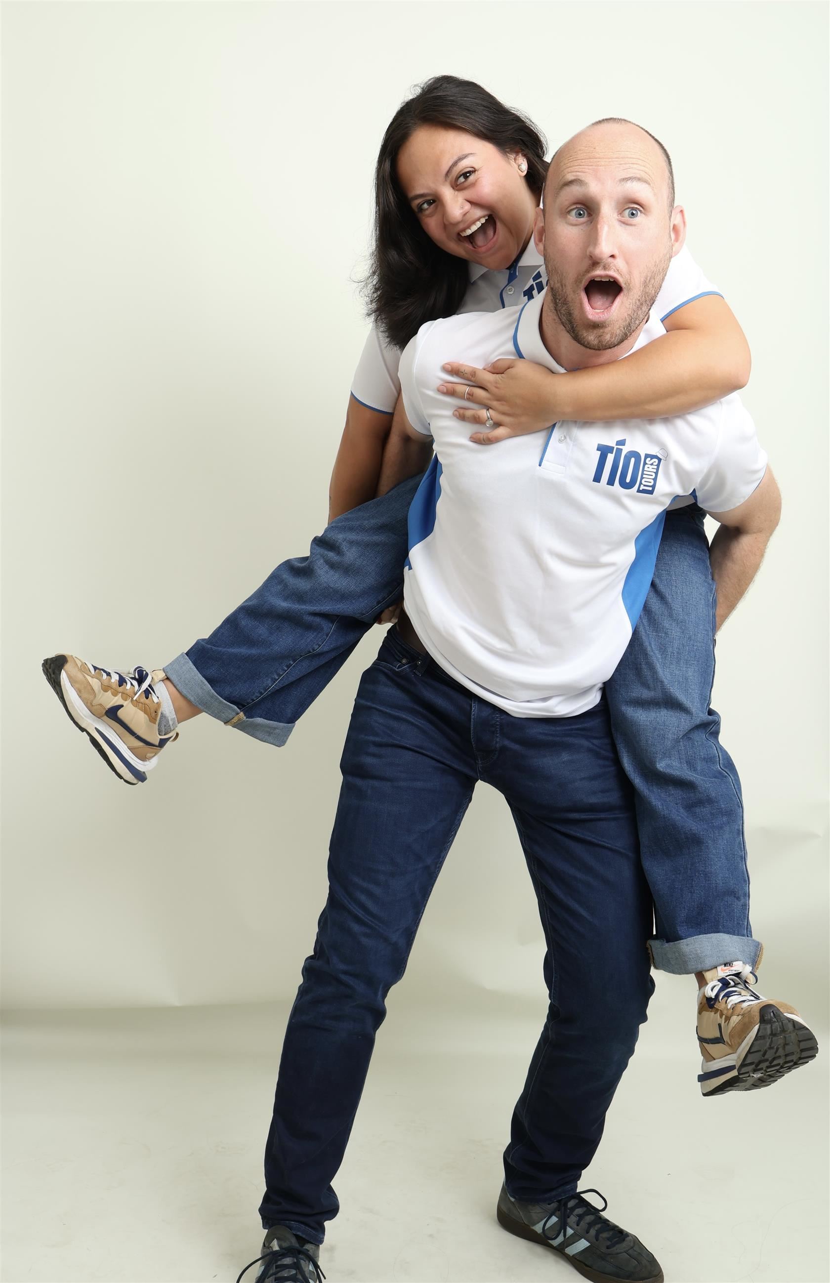 Emely Barahona and her boyfriend pose piggyback and wear their Tio Tours shirts