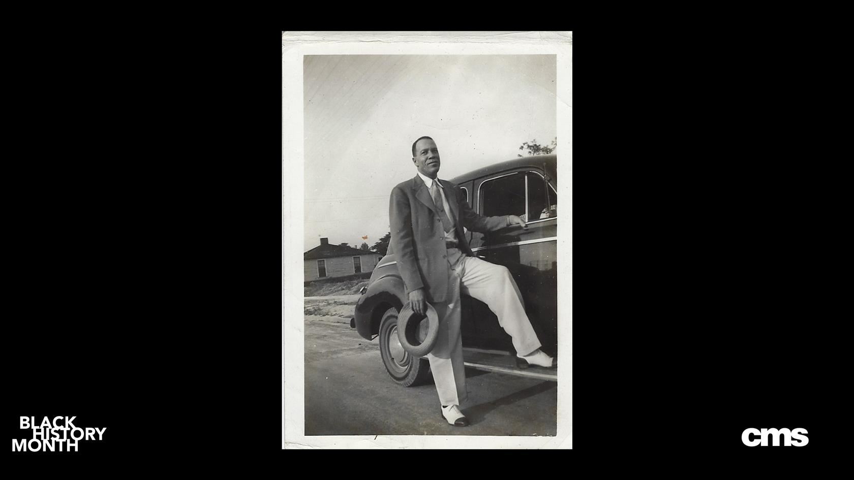  Long time, former CMS principal Walter G Byers stands by his vintage car wearing a snazzy suit
