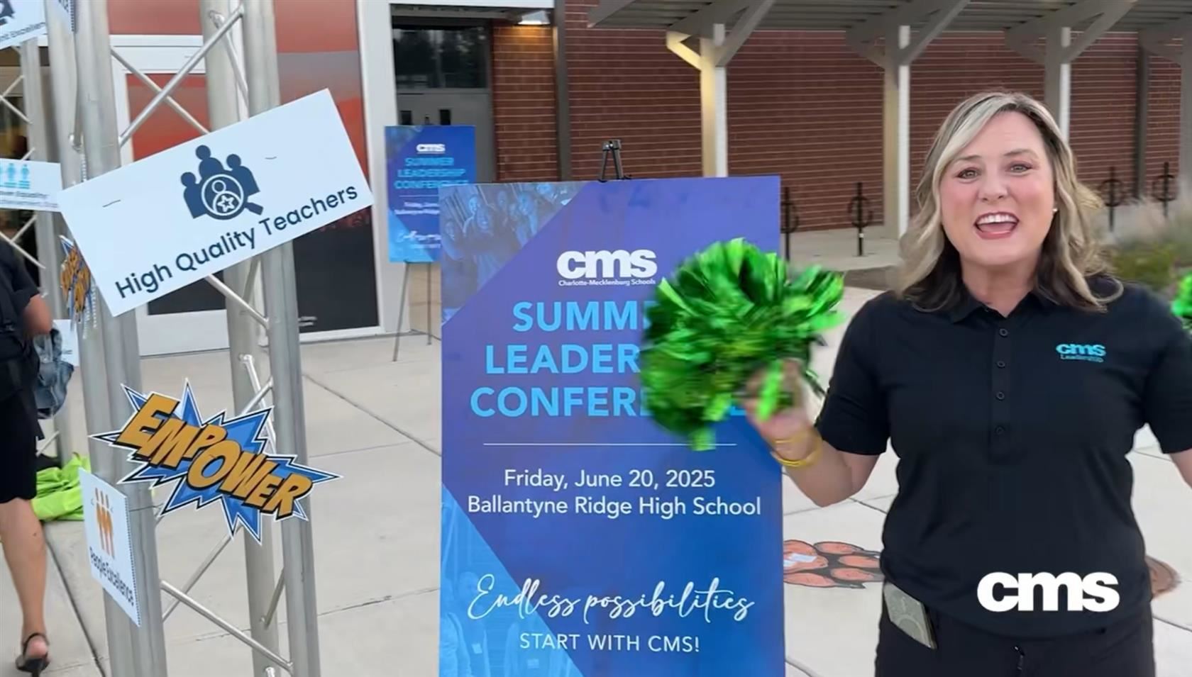 People welcome attendees with cheering and pom-poms as they arrive to the conference.