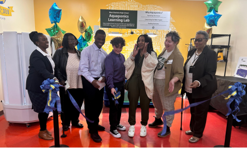 West Charlotte High School students, staff and partners cut the ribbon to the new aquaponics system.