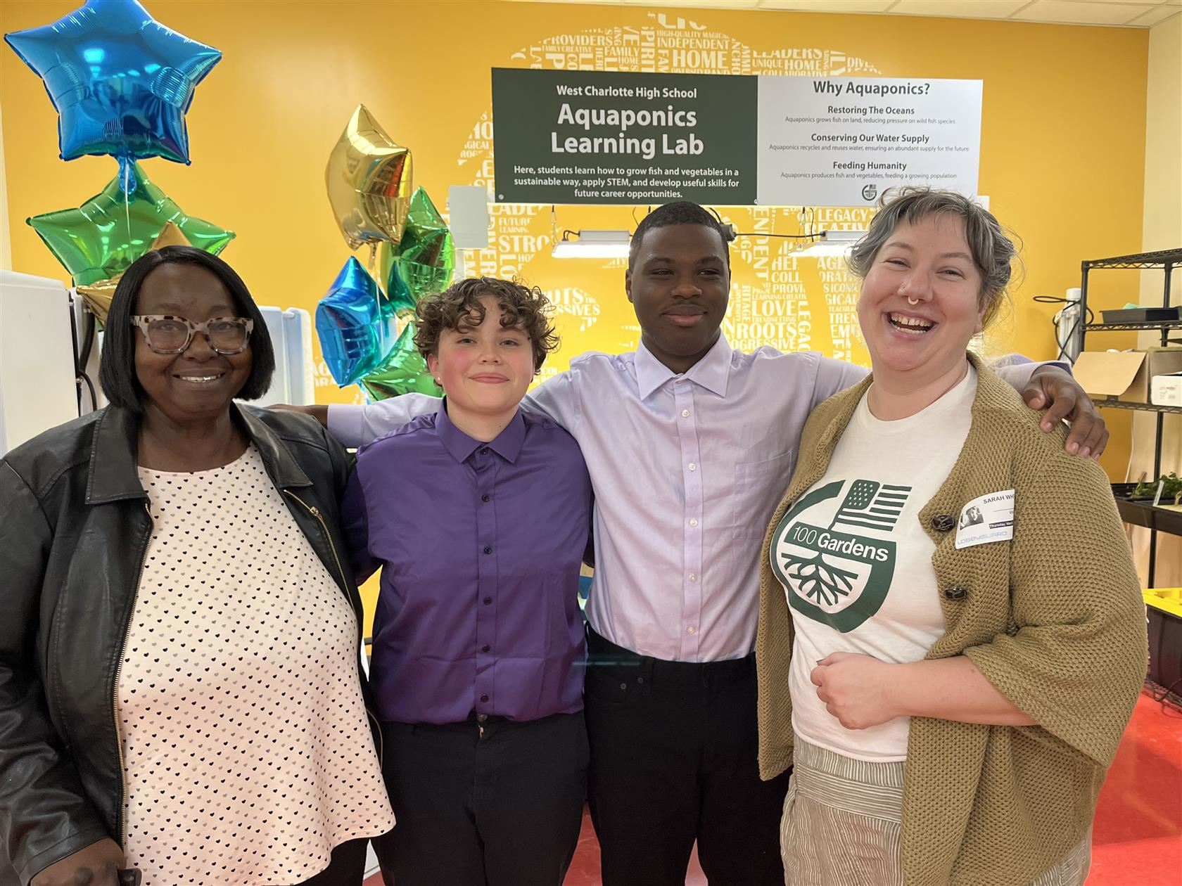 West Charlotte High students Kim Cisneros and Lamont Johnson stand with West Charlotte staff and 100 Gardens representative