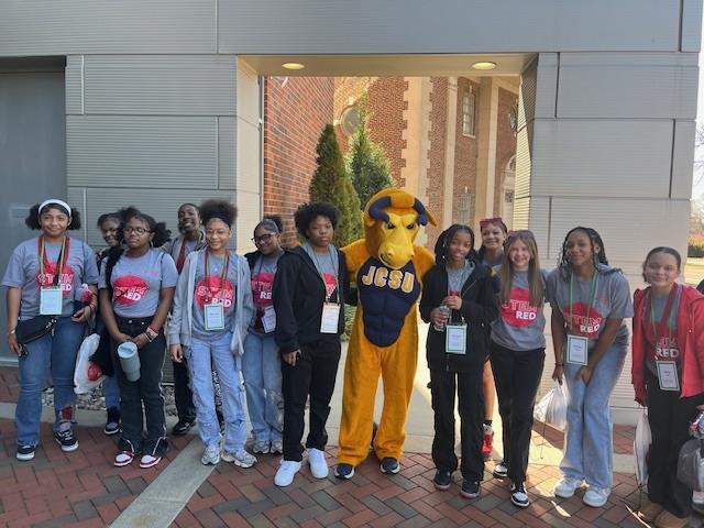 Middle school students stand with JCSU's mascot