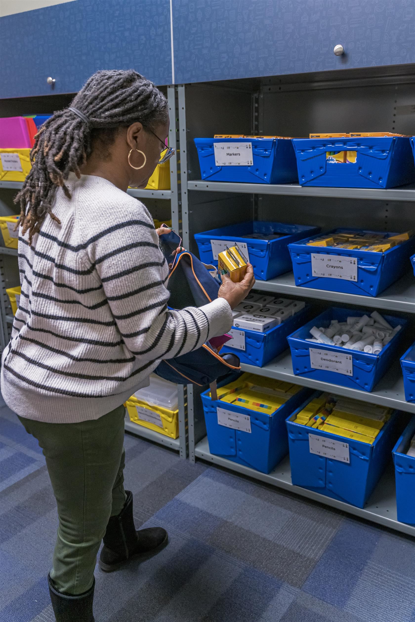 Exceptional Children teacher Valda Oliver grabs supplies from the Learning Locker 