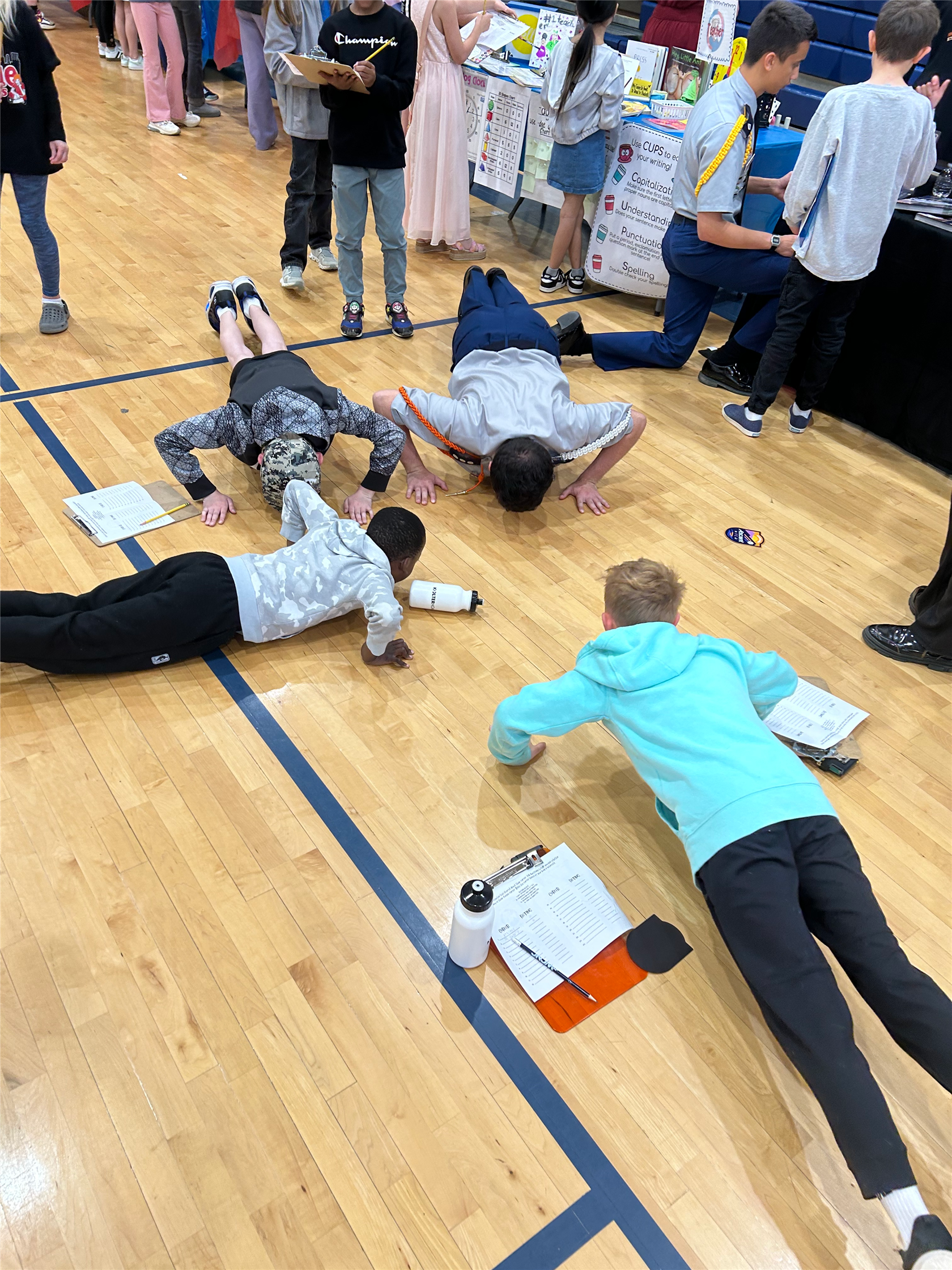 Students doing pushups with a military recruiter.
