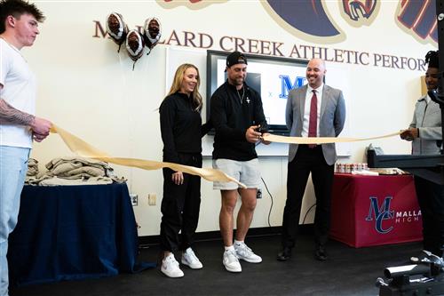 Thielens cut ribbon on Mallard Creek weight room.