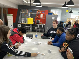 Students learning to play Spades
